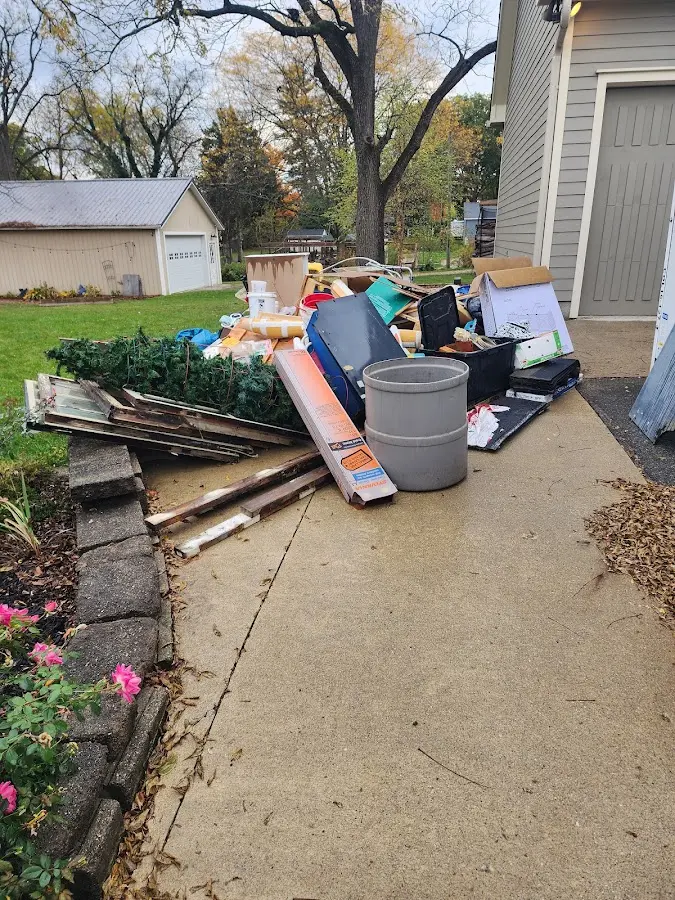 Dumpster being loaded with debris for Commercial Dumpster Rental in Madison